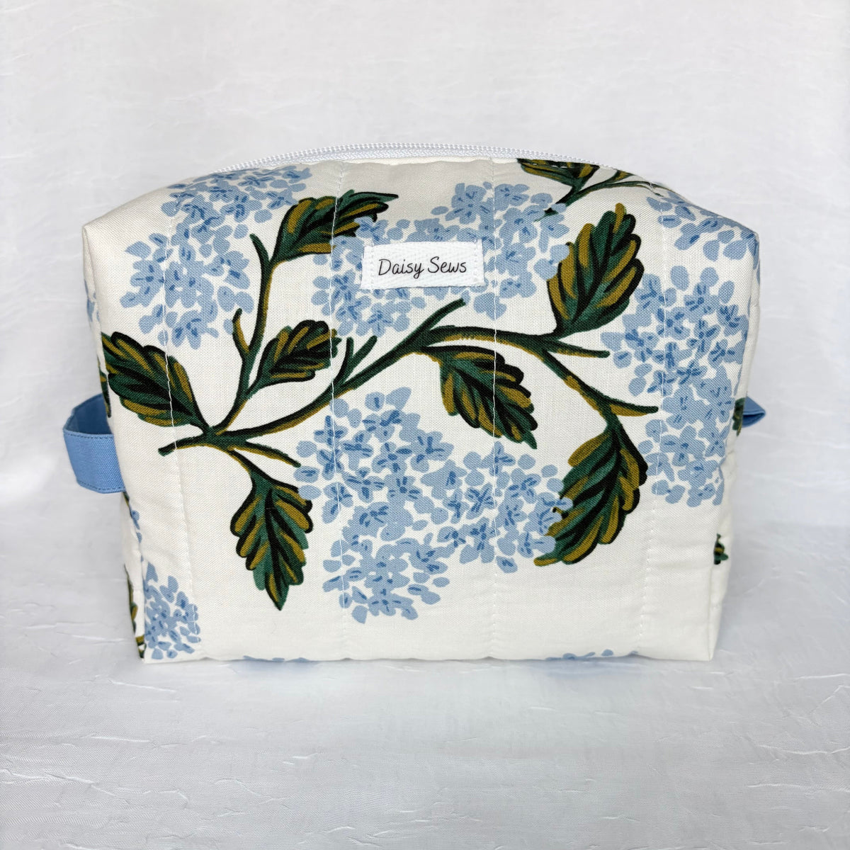 large Blue Hydrangeas with green leaf design boxy bag with blue handle and tab on white background