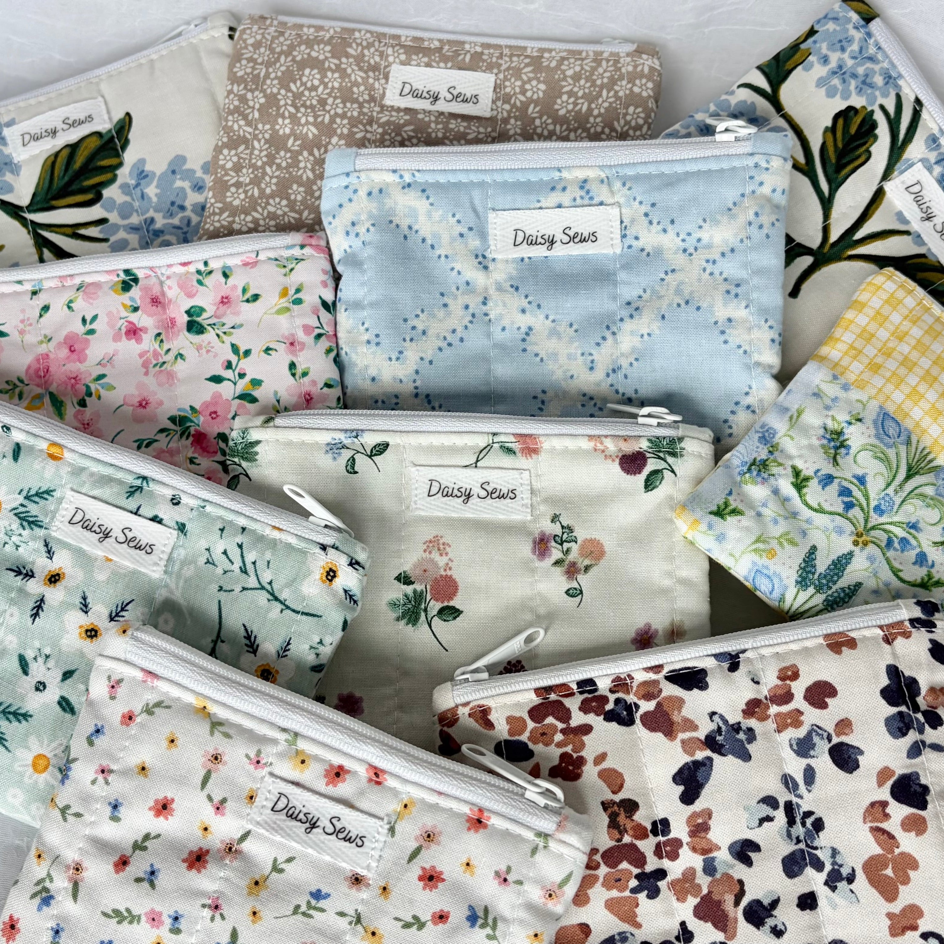 Organized pile of floral and patterned small zipper pouches