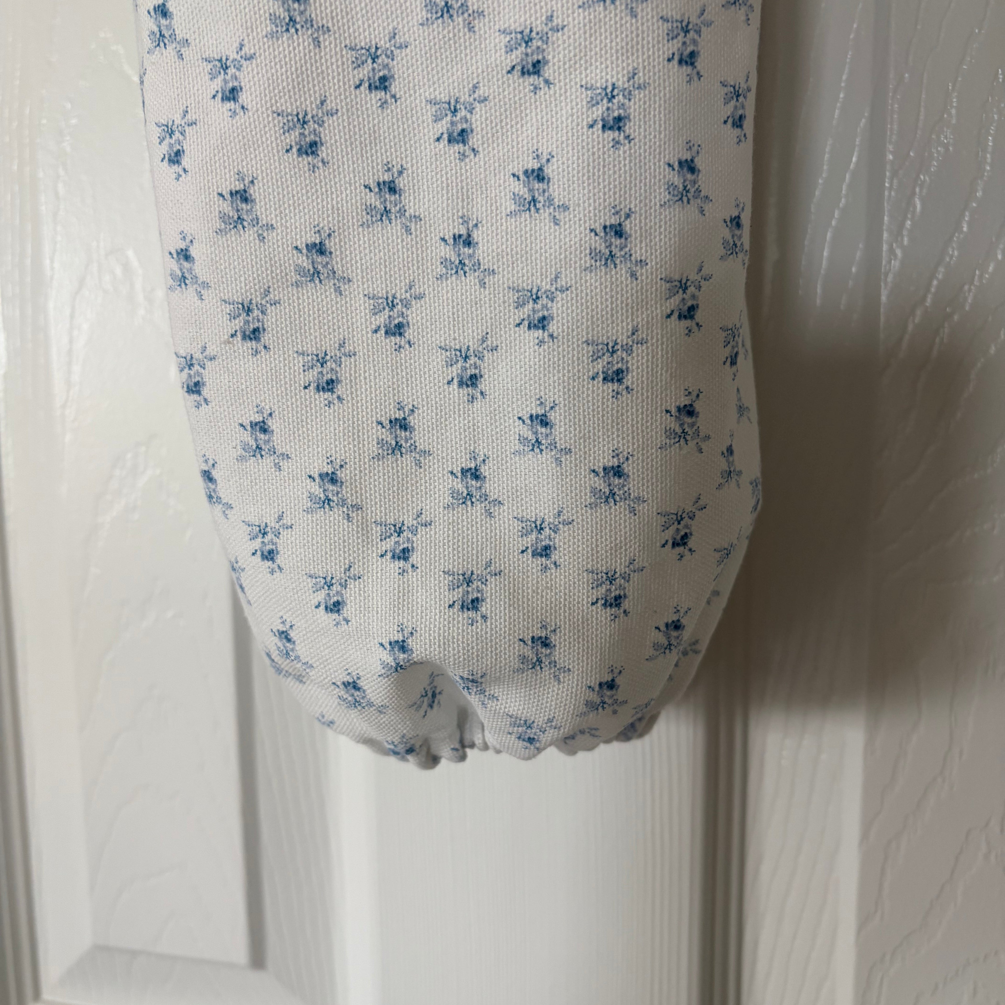 Bottom view of white with blue flowers showing elastic holding bottom together