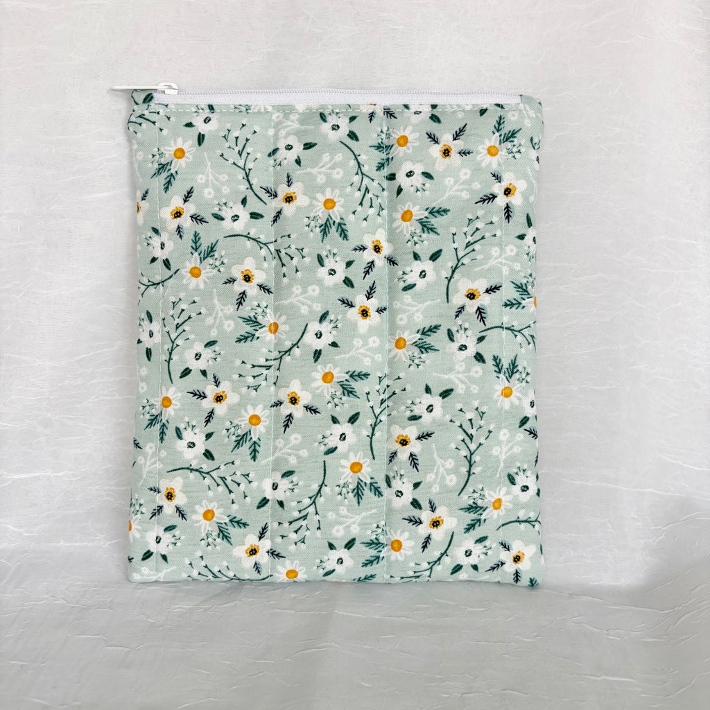back blue with white flowers and teal leaf design plush, flat pouch with white zipper on white background