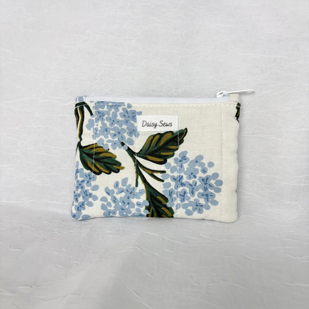Blue Hydrangea with green leaf patterned Pouch with white zipper on white background