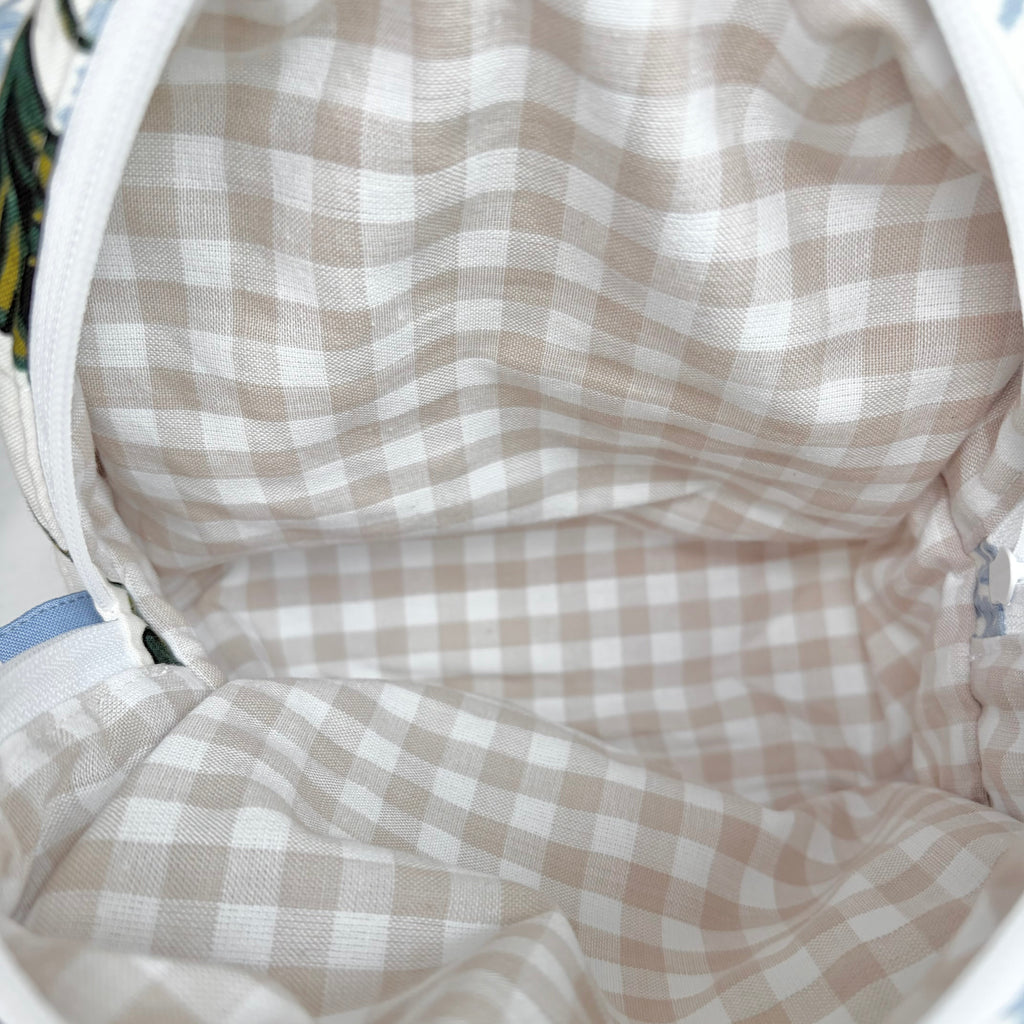 close up of beige gingham interior and white zipper