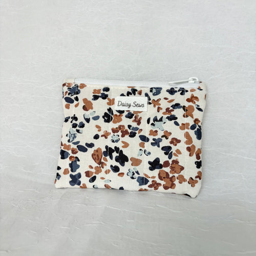 Blue and Mauve speckled pouch with white zipper on white background