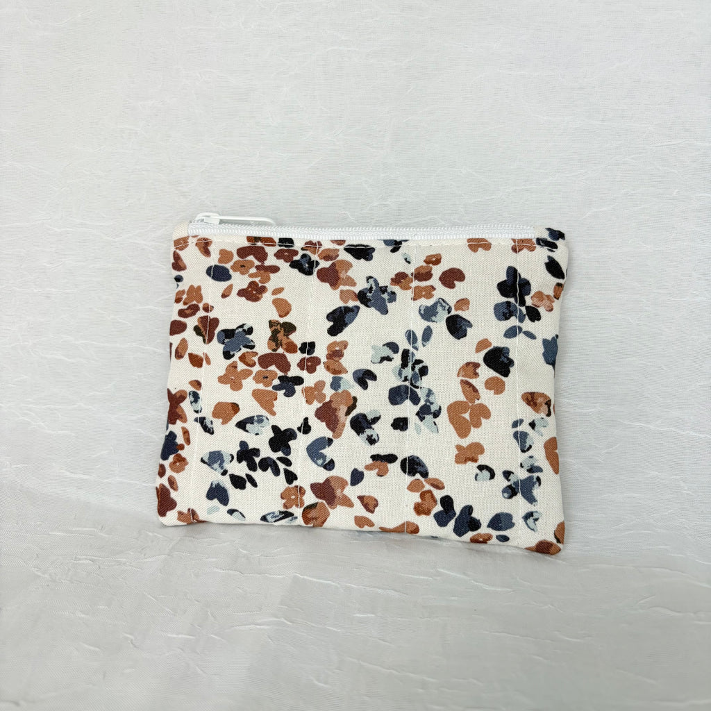 back side of Blue and Mauve speckled pouch with white zipper on white background