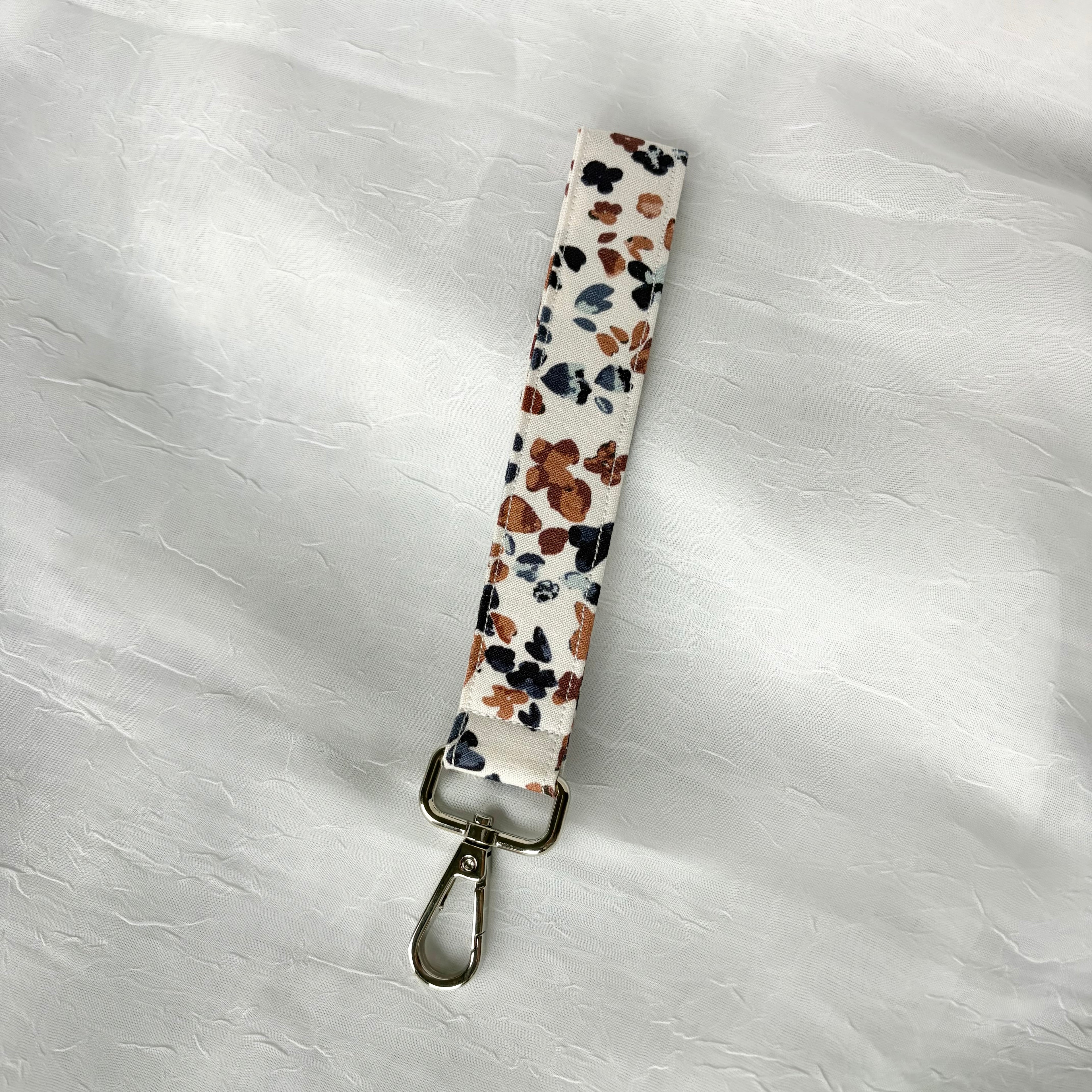 navy blue and mauve dot clusters on white fabric keychain wristlet with silver lobster clip