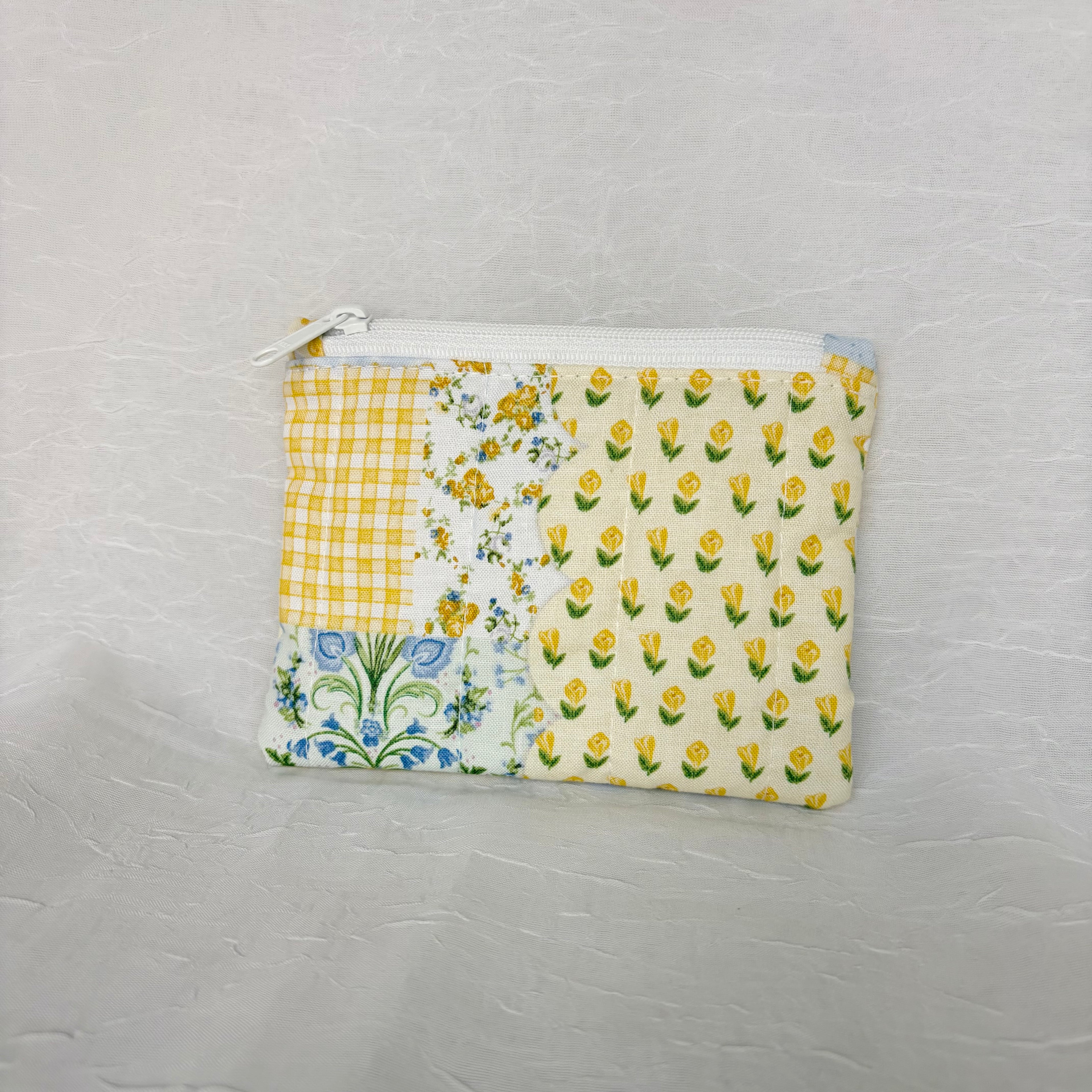 back of Blue and Yellow floral Patchwork small Pouch with white zipper on white background