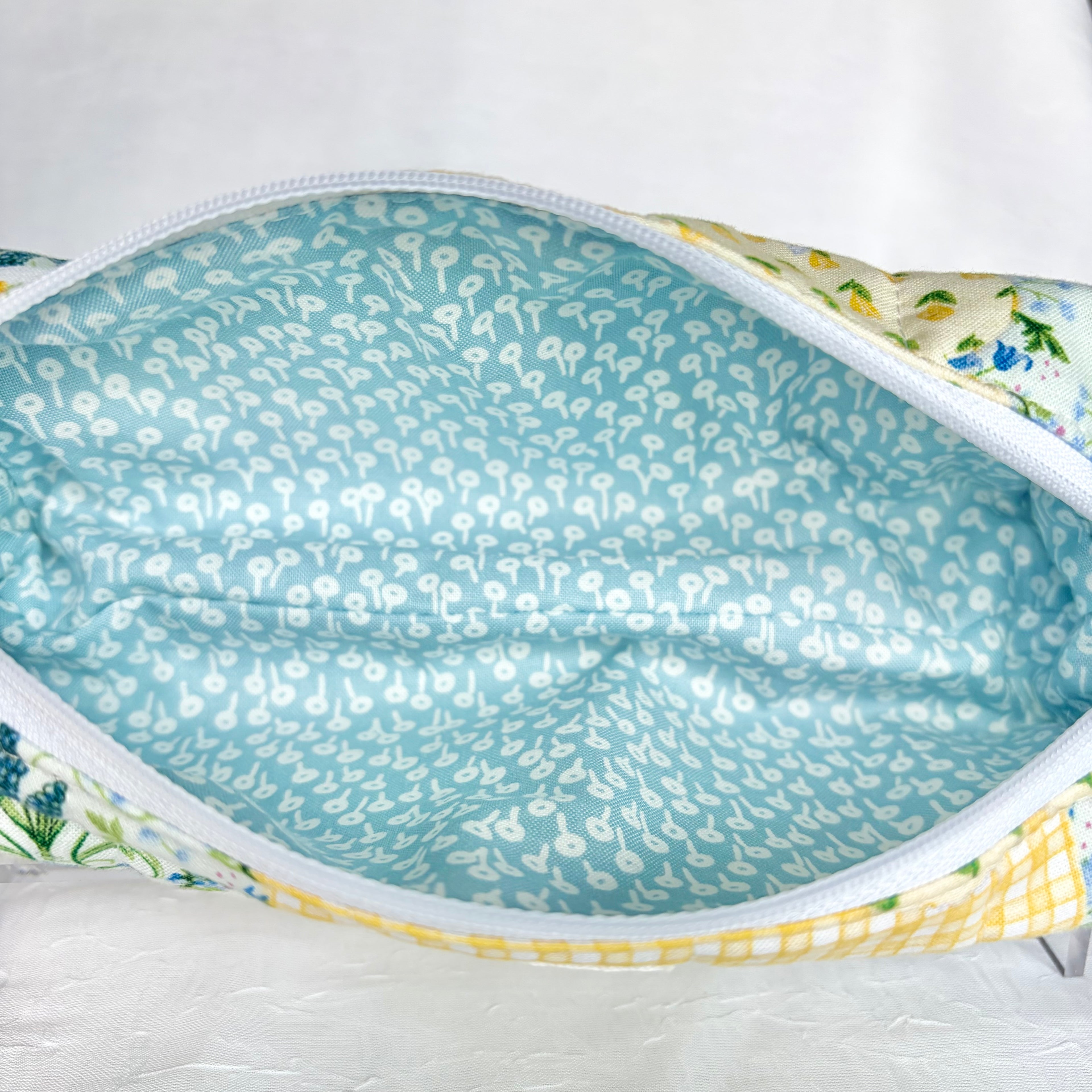 Close up of Blue liner with white flower design and white zipper
