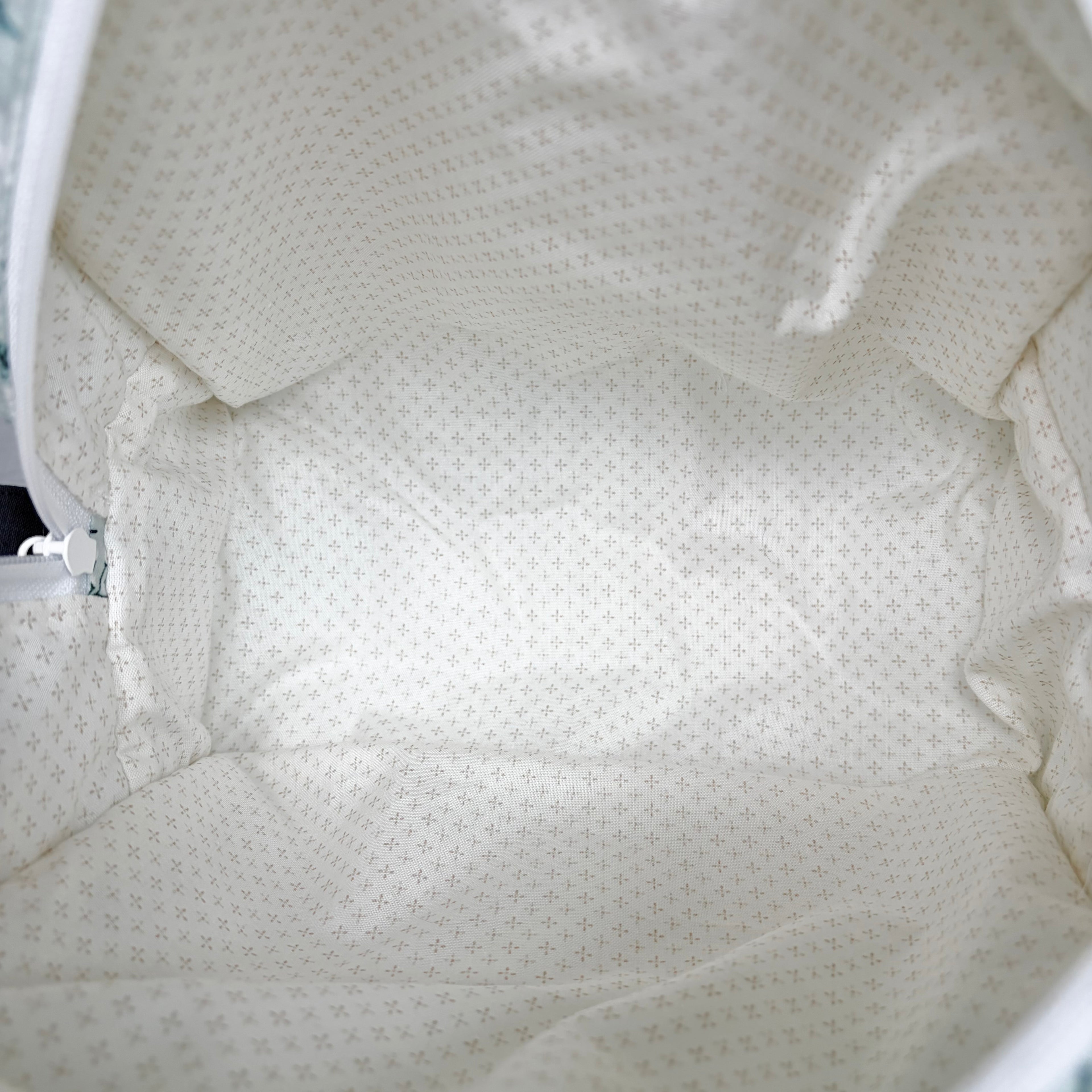 close up of cream with brown dots in cross patterned interior