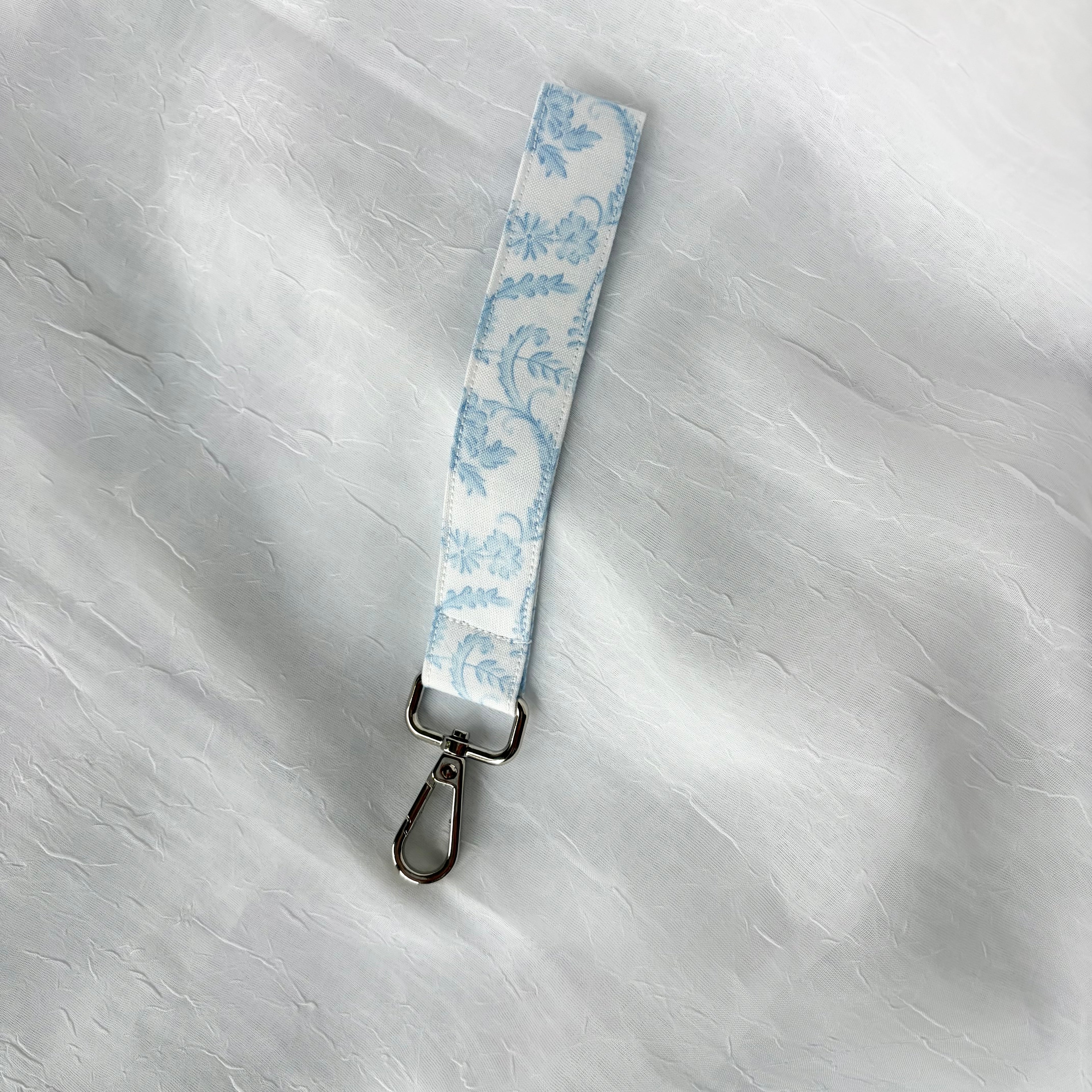 light blue pattern on white fabric keychain wristlet with silver lobster clip
