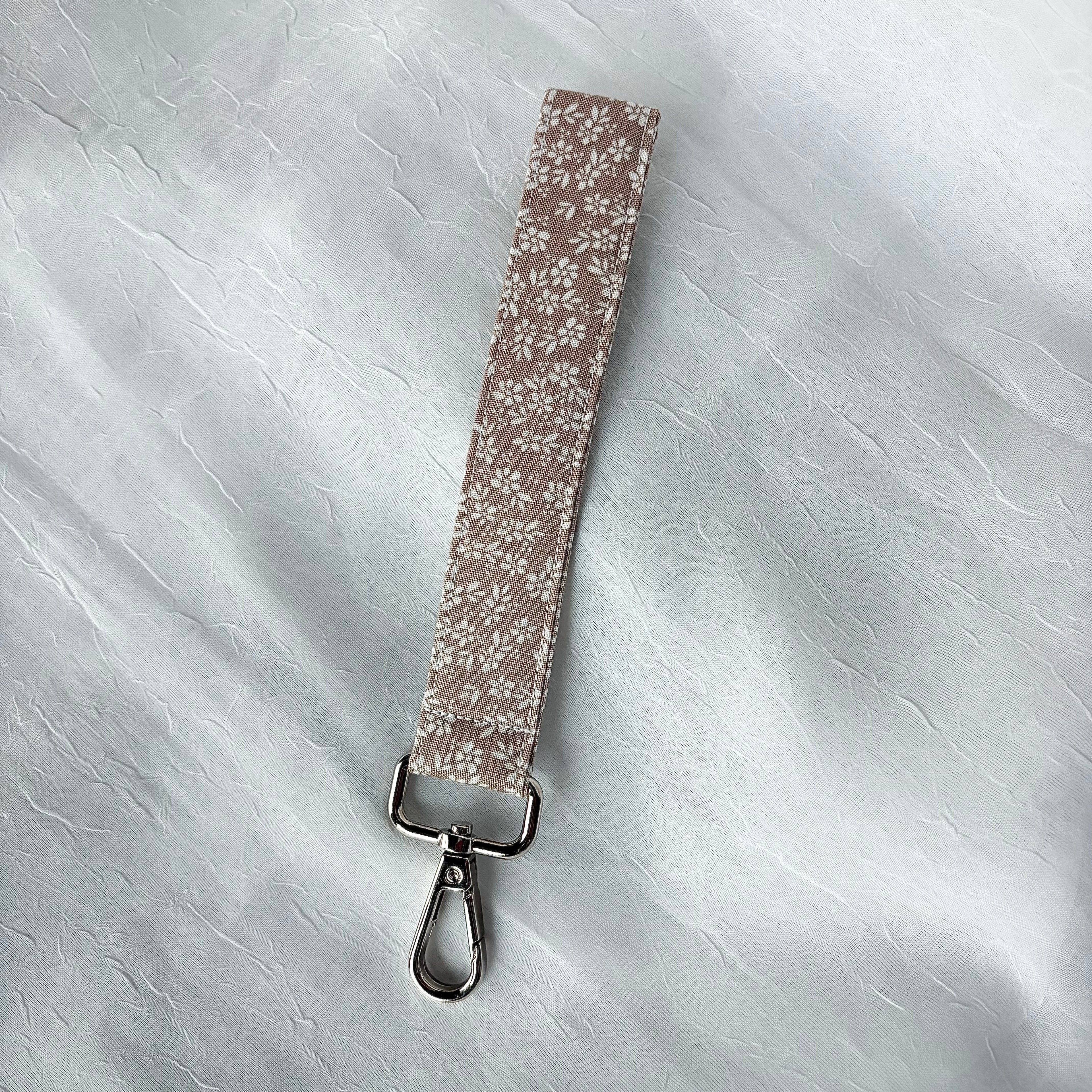 Cream flowers on brown fabric keychain wristlet with silver lobster clip