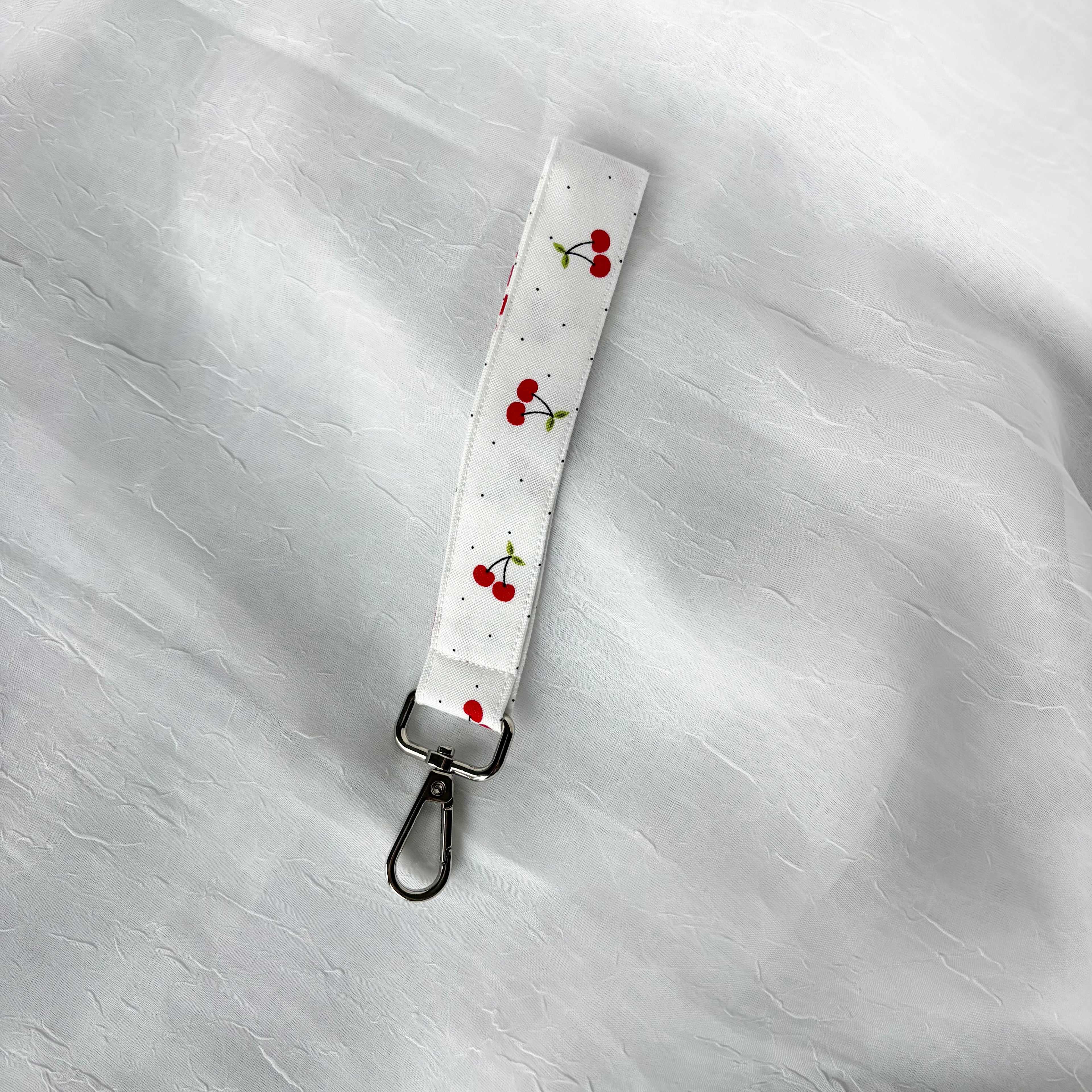 cherries and tiny black dots on white fabric keychain wristlet with silver lobster clip