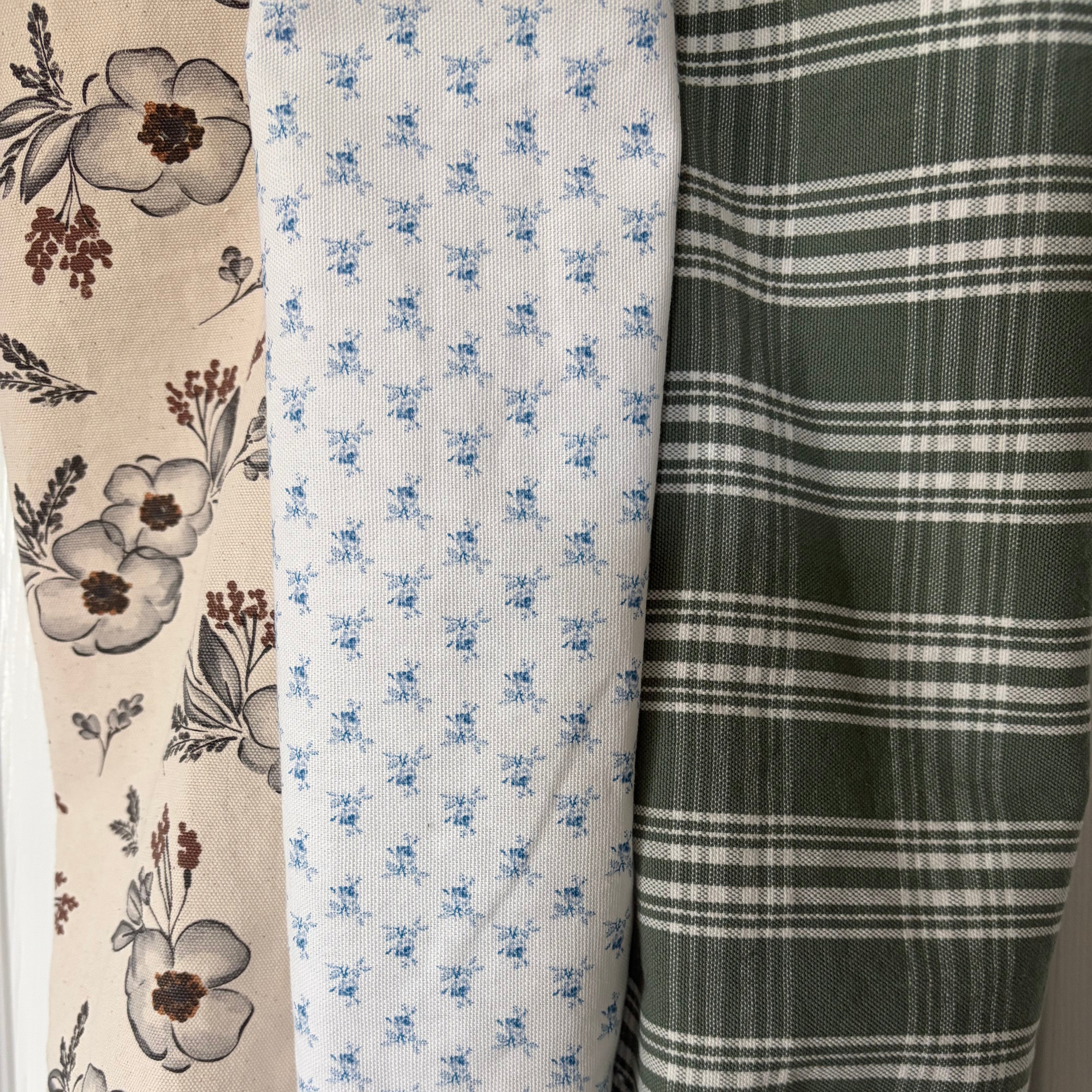 Neutral floral with grays and browns on crean, small blue flowers on white and white plaid on green