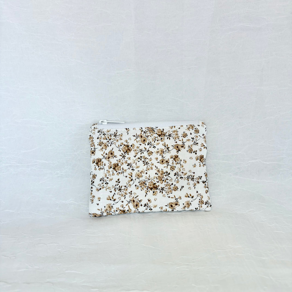 brown Floral-patterned pouch on a light gray background