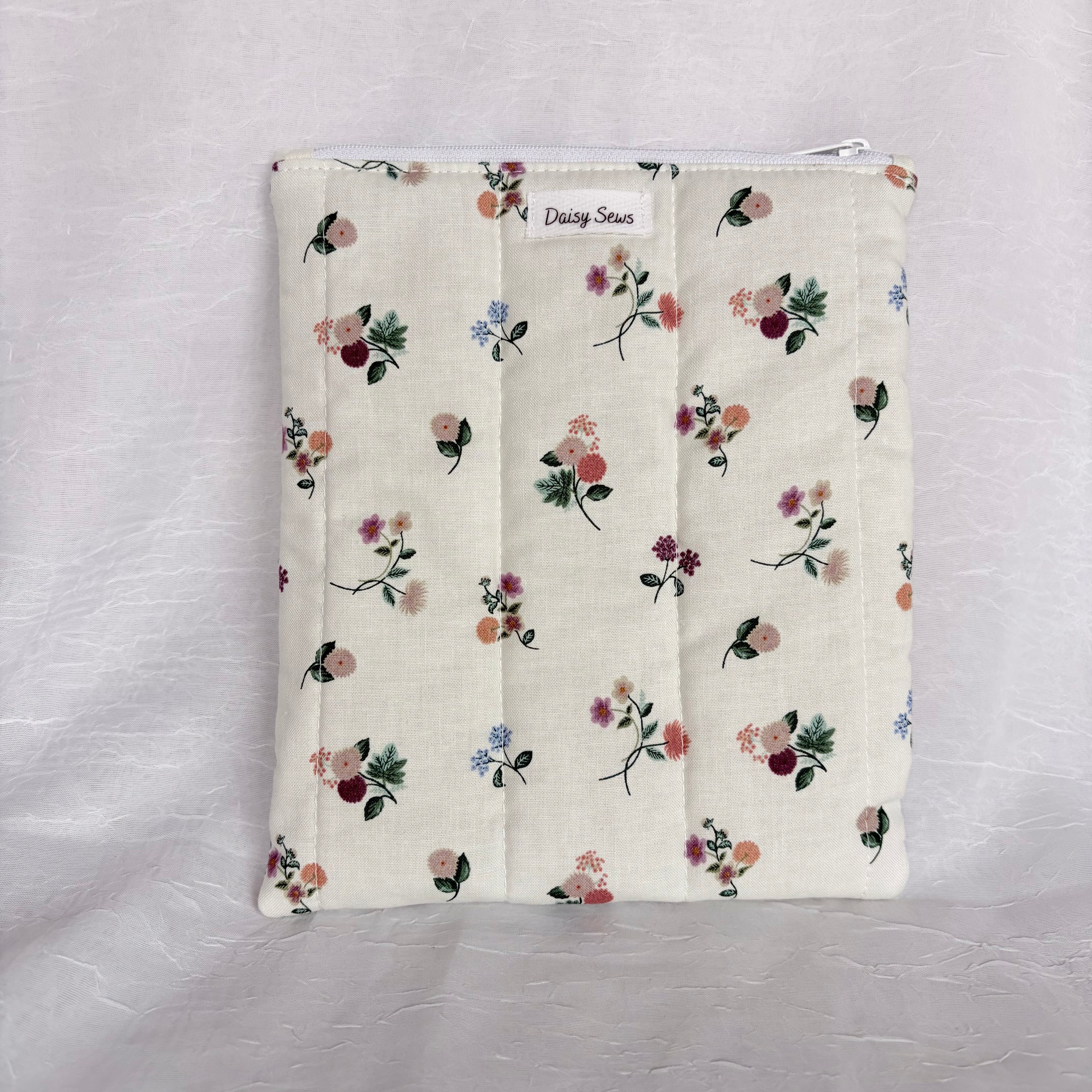 Floral on Cream plush, flat pouch with white zipper and label on white background
