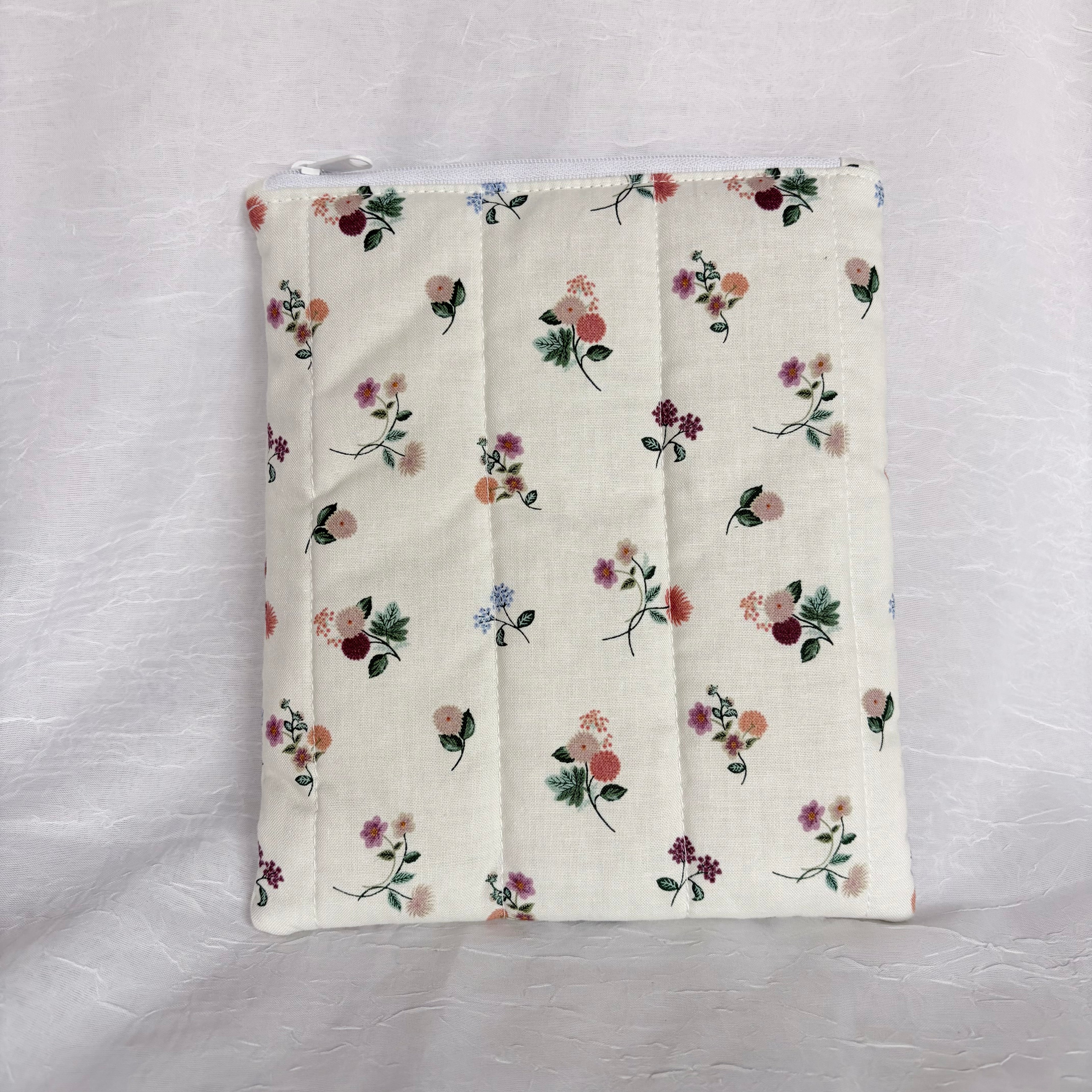 back Floral on Cream plush, flat pouch with white zipper and label on white background