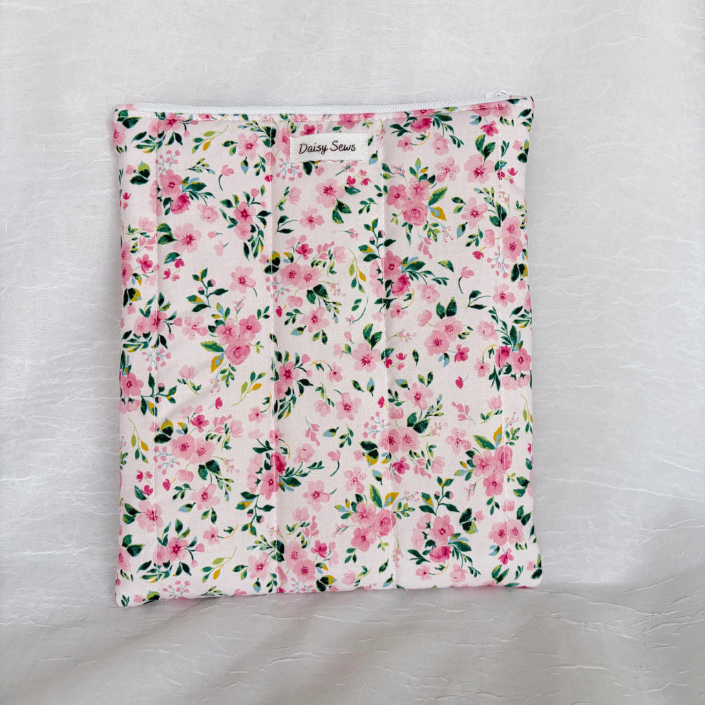 Pink floral with green leaf designed flat, plush pouch with white zipper and label on white background