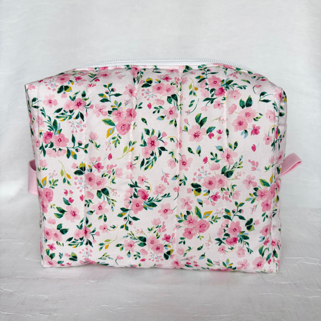 back view of pink floral with green leaf patterned boxy bag on white background