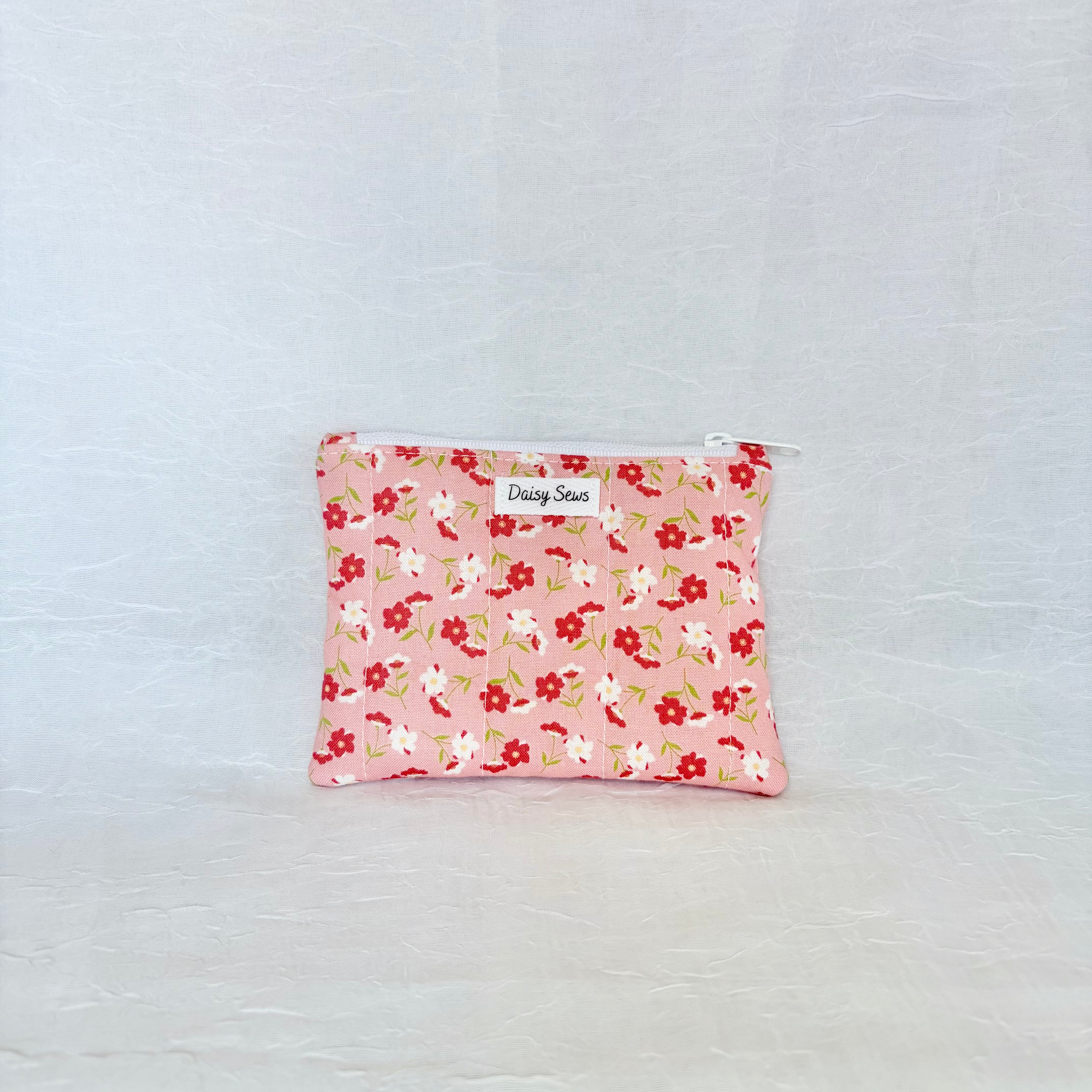 Floral patterned pouch on a light gray background