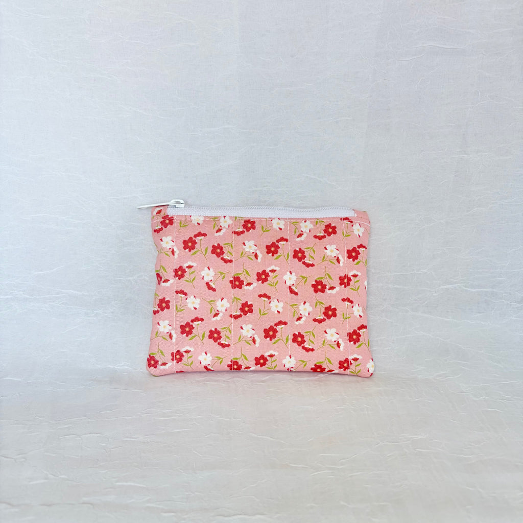 pink Floral patterned pouch on a light gray background