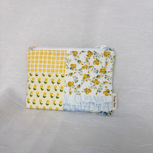 Blue and Yellow floral Patchwork small Pouch with cream tag on bottom right corner on white background