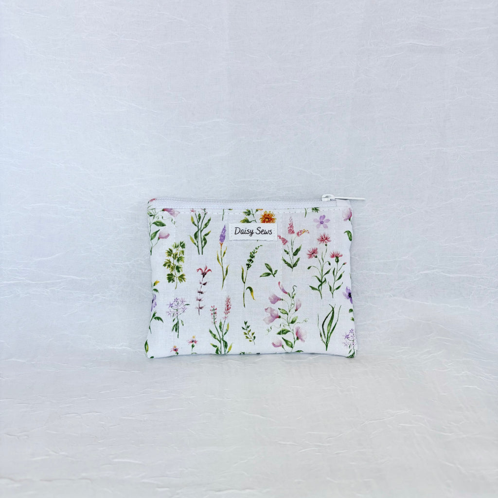 Floral patterned pouch on a light gray background