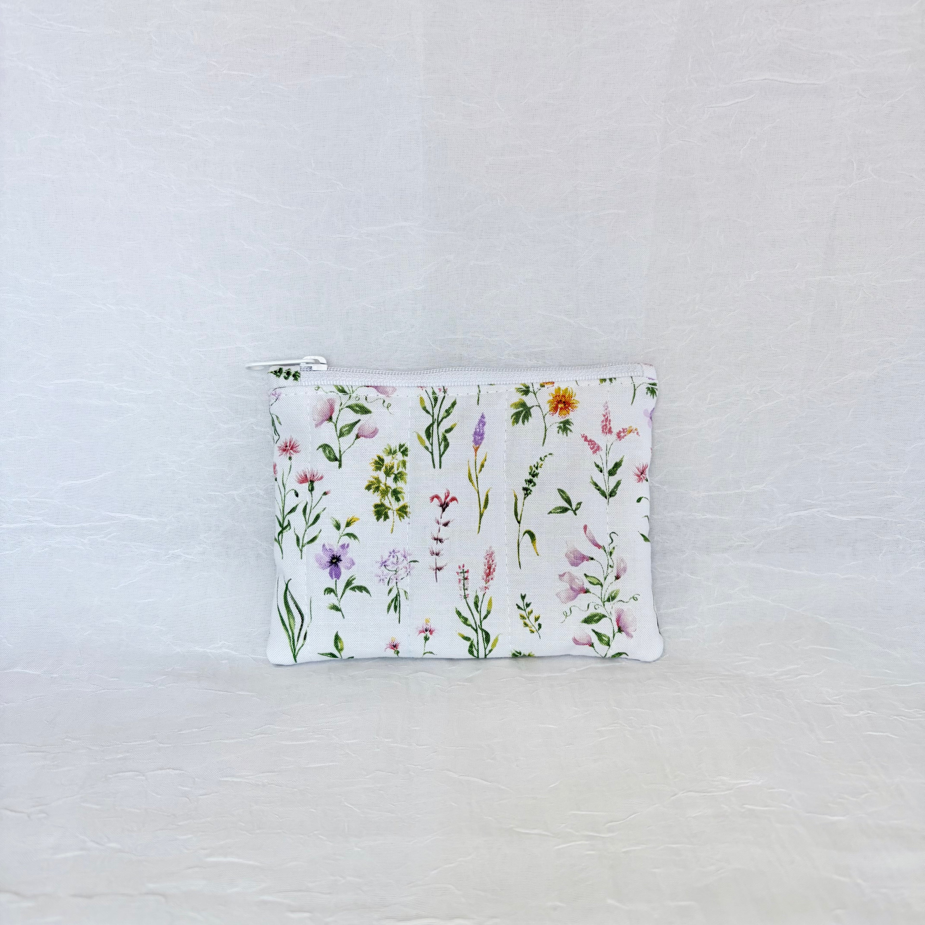 Small pouch with floral pattern on a light gray background