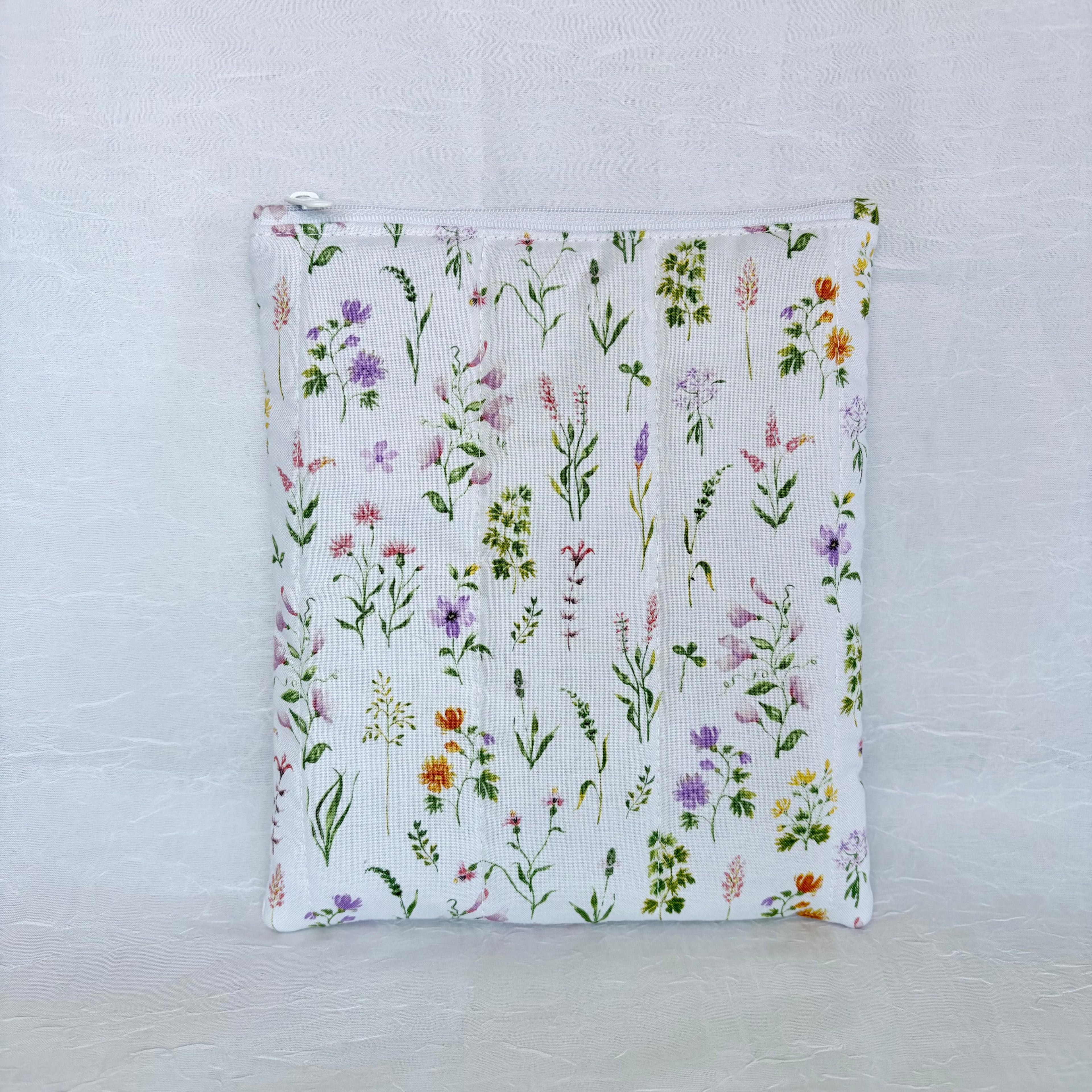 Floral-patterned pouch on a textured white background