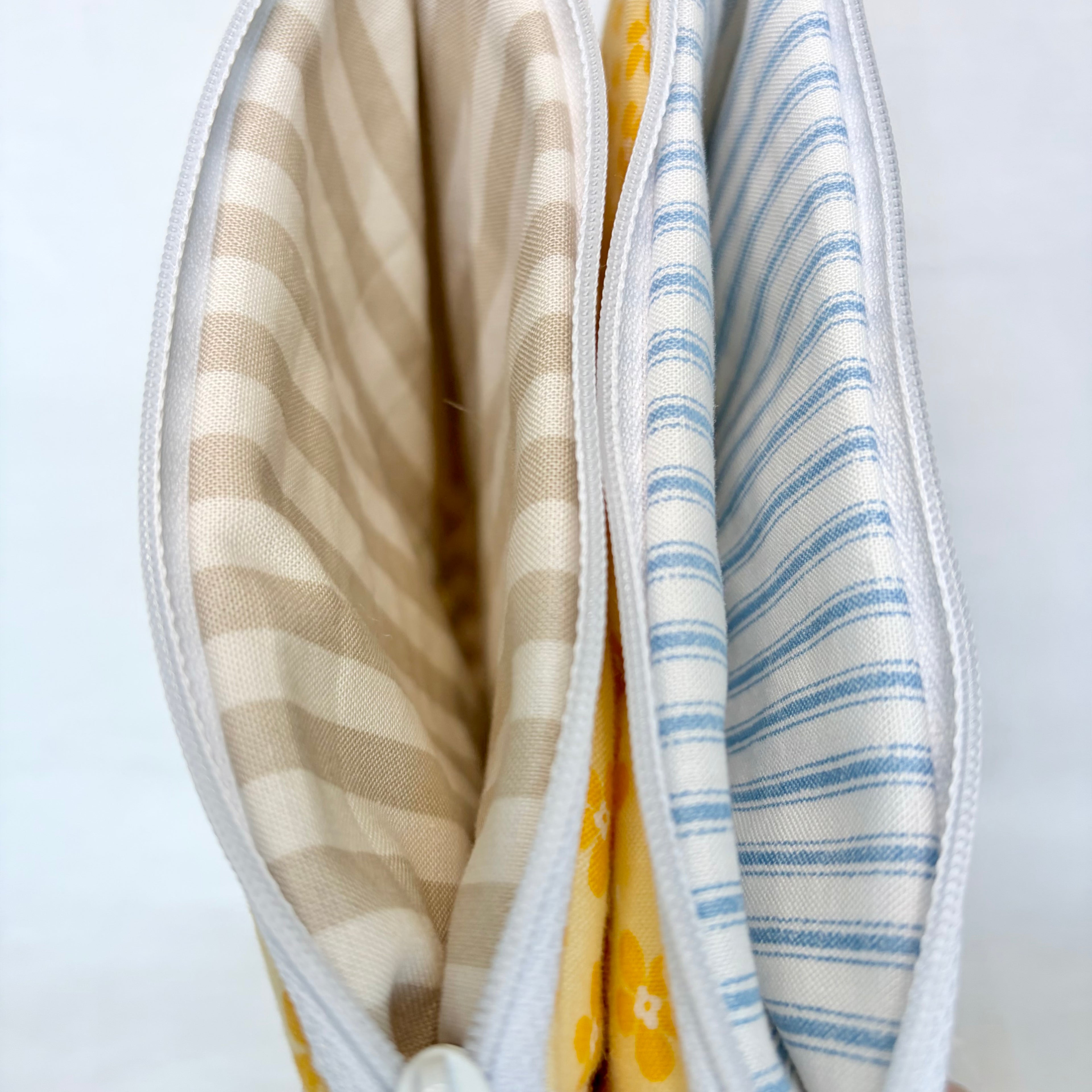 Close-up of a tan striped liner and blue striped liner 