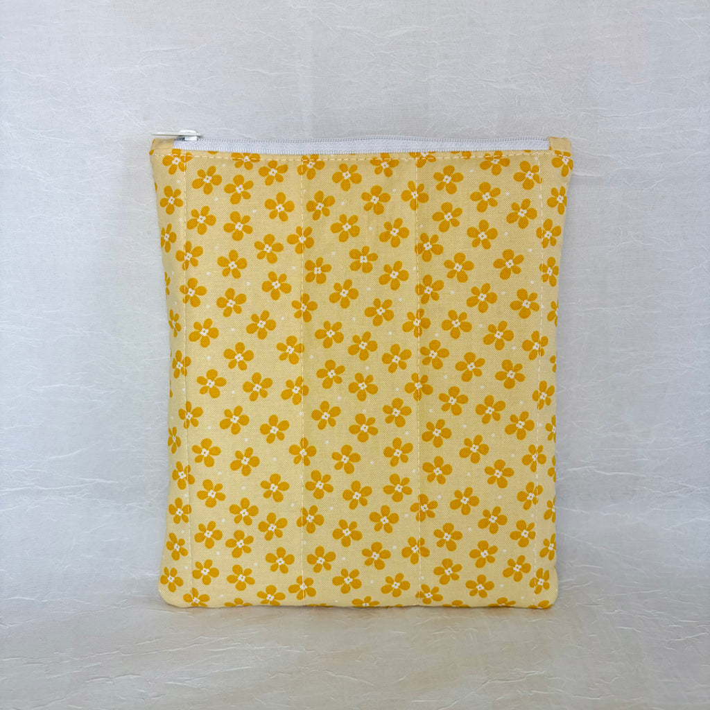 Yellow fabric pouch with floral pattern on a white background